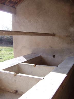 Vue des bassins en ciment arm et des muret de surverse du lavoir couvert des Bernes, Saint Julien le Montagnier.
