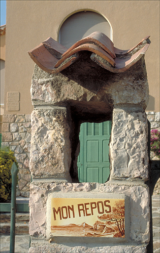 Dtail, plaque vernisse avec nom de la maison, sur un pilier du portail.