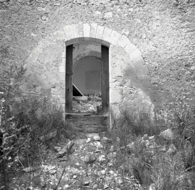 Porte d'entrée à demi murée.