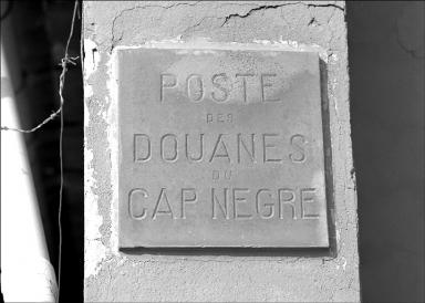 Dtail, plaque portant la fonction de l'difice situe sur le mur de clture. (maison construite vers 1920).