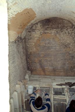 Vue intrieure de la chambre du four industriel  bois. Matriel d'enfournement. Pose des manchons rfractaires. Encabanage des carreaux  l'aide de briques.